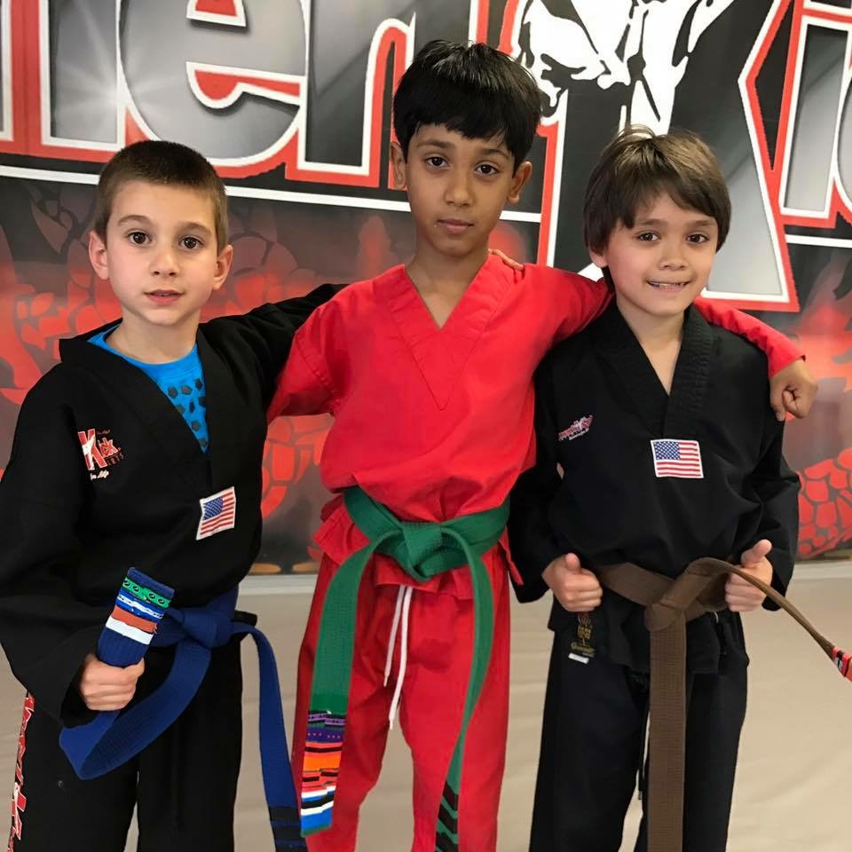 three karate boys in embrace